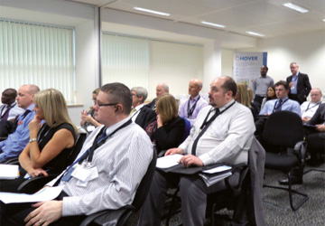 an audience of business people watching a presentation 