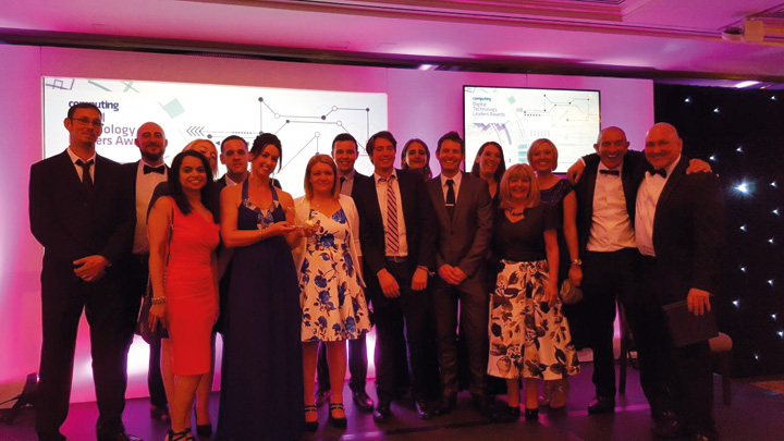 a group of people dressed up at an awards ceremony, one of them is holding an award