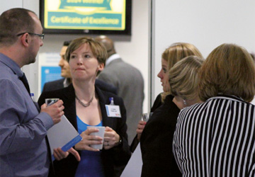 business people standing drinking tea and chatting