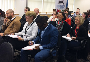 business people sitting with notebooks on their laps