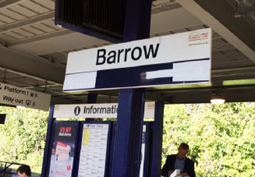 'Barrow' station sign with the information sign in the background