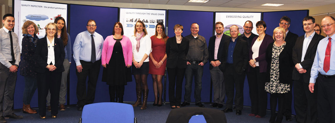 business people standing in a row smiling